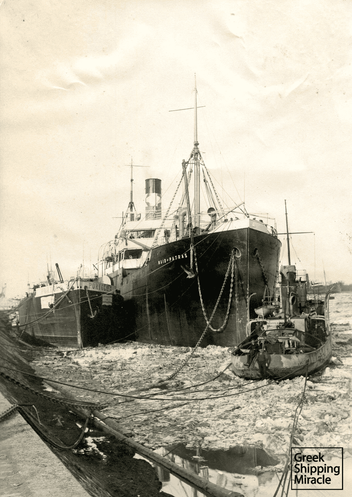 The Greek-owned British-flagged MAID OF PATRAS in the early 1920s at the frozen port of Braila. The Greek-owned barge PORTOLO 7 is pictured on the left