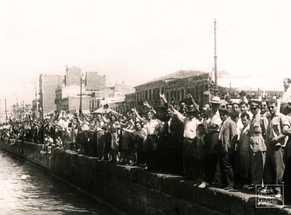 59. Greek citizens welcome the ocean liner NEA HELLAS on her first post-war arrival at the port of Piraeus in 1947.